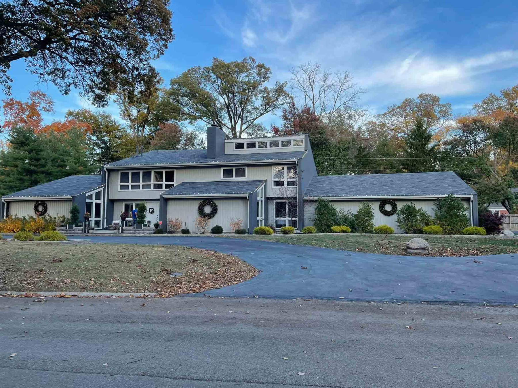 Long Indiana commercial building with lighted Christmas wreaths spaced along the front